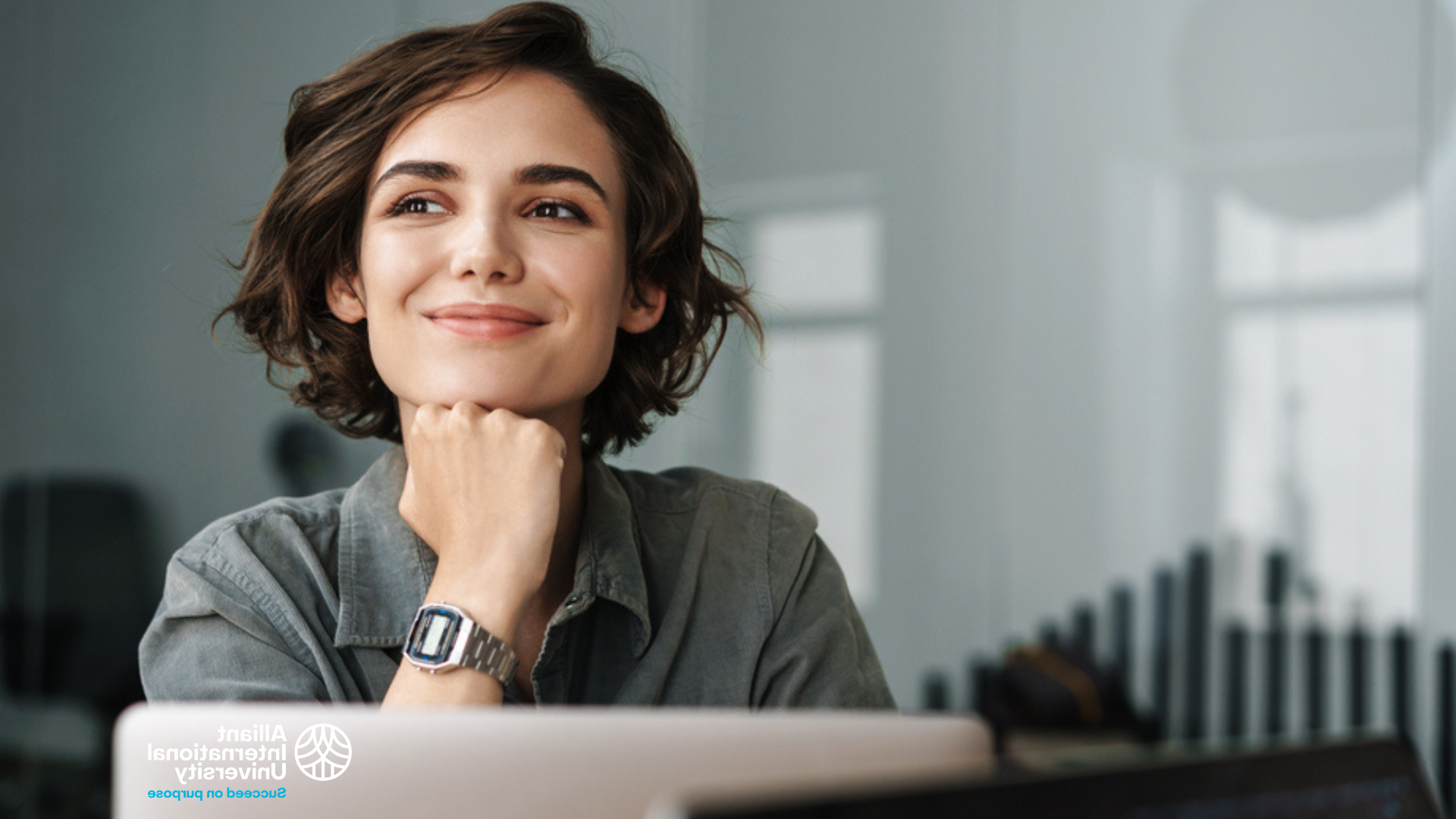 Woman thinking while in front of laptop